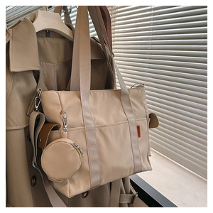 Detailed view of beige canvas tote bag with side pocket and matching round coin purse
