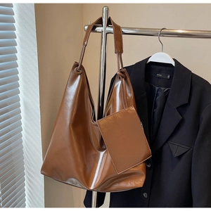 Detail view of large dark brown leather hobo bag with matching small coin purse