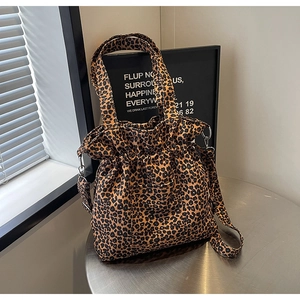Detailed close-up of leopard print canvas tote bag with drawstring and front pocket