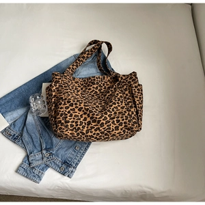 Dettaglio di una capiente borsa shopper leopardata con tasche laterali e design casual