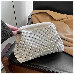 Detail of elegant shell evening bag featuring sparkling silver rhinestones and metal frame