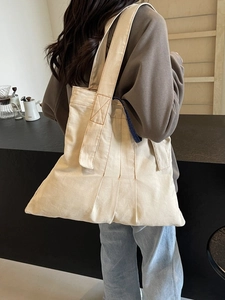 Minimalist cream canvas tote bag with retro brown stitching for vintage aesthetic
