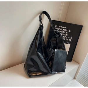 Detail shot of large capacity glossy black tote bag with matching small pendant pouch