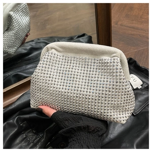 Close-up of elegant cloud-shaped evening bag with silver rhinestones and gathered folds