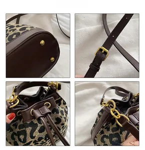 Detailed views of leopard print bucket bag with gold hardware and leather drawstring strap