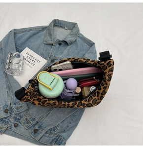 Leopard print crossbody bag showing large storage capacity for phone, umbrella and daily items