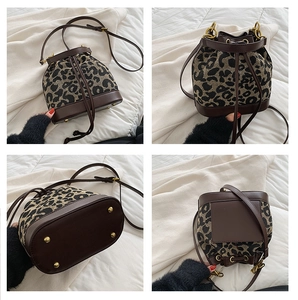 Detailed views of leopard print canvas bucket bag with brown leather trim and gold hardware