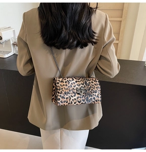 Gros plan sur le sac baguette léopard avec clous argentés et détails de la bandoulière