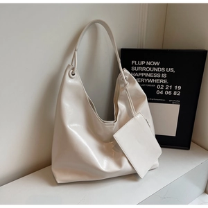 Detail view of cream white Hobo shoulder bag with smooth leather texture and zip pouch