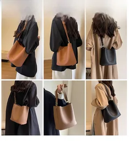 Sac seau à motif litchi avec large bandoulière réglable et détails métalliques dorés