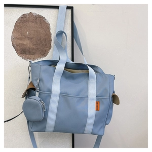 Light blue nylon tote bag detail with orange label and detachable mini round coin purse