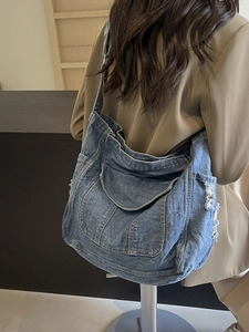 Large blue washed denim tote bag for women with vintage distressed fringe details