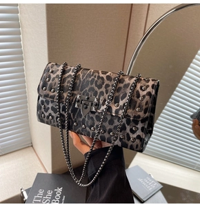 Détail du sac baguette à imprimé léopard avec clous métalliques et bandoulière