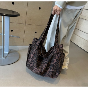 Close-up of leopard print tote bag side pocket and durable fabric texture in daily use