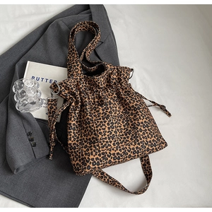 Detailed shot of leopard print canvas tote with dual straps and drawstring closure
