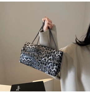 Détail du sac à main léopard gris avec des clous métalliques et bandoulière chaîne