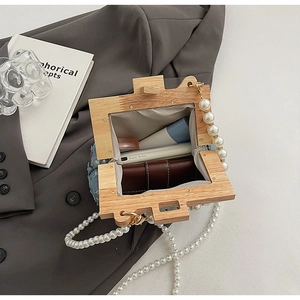 Detail view of wooden frame shell bag interior showing large capacity for phone and wallet