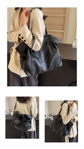 Detail of black tote bag with silver star rivets and soft PU leather texture