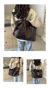 Close-up of retro dark brown leather tote bag with dual straps and spacious interior