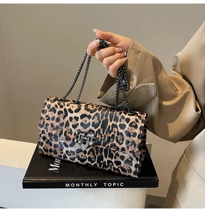 Gros plan du sac à bandoulière léopard avec rivets métalliques et bandoulière chaîne
