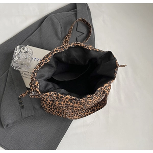 Top view of leopard print canvas tote bag showing black lining and inner pocket detail