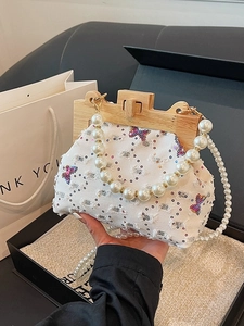 Denim shell bag with sequined butterfly, wooden frame, and pearl bead handles
