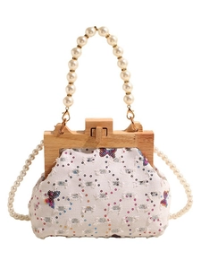 Chic denim shell handbag with butterfly sequins, pearl handles, and wooden frame closure