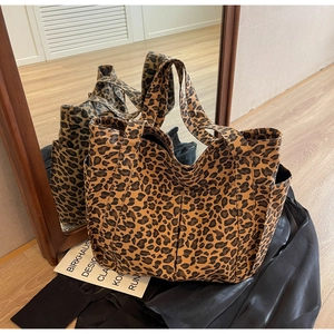 Detailed side view of the leopard print tote bag showing the side pocket and fabric texture