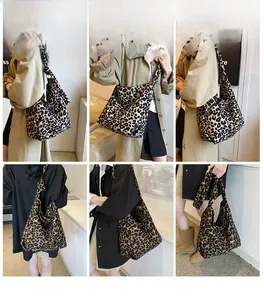 Detailed views of leopard print canvas crossbody bag showing large storage capacity