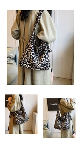 Detail shot of large capacity leopard print canvas tote bag showing wide shoulder straps