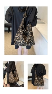 Detail of trendy leopard print canvas tote bag with adjustable knotted shoulder strap