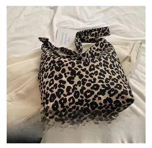 Detail shot of the large leopard print canvas tote bag with thick shoulder strap texture