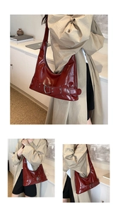 Detail of burgundy crescent shoulder bag in glossy patent leather with metal buckle
