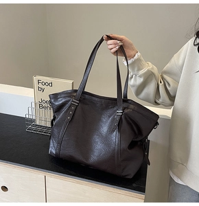 Detail of silver star rivets on premium dark brown leather tote bag for women