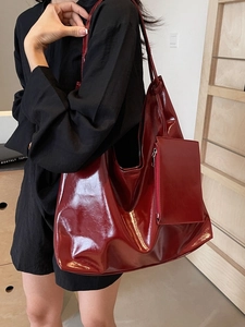 Large dark red patent leather tote bag with matching pouch for stylish women commute
