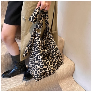 Detail of leopard print canvas bag with large metal ring and spacious hobo design