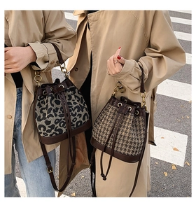 Outdoor shot of leopard print and houndstooth bucket bags with leather drawstring detail