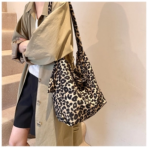 Close-up of stylish leopard print canvas tote bag with wide shoulder strap details