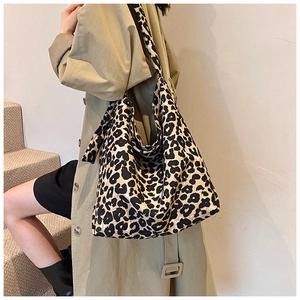 Close-up of leopard print canvas tote bag with spacious interior and wide shoulder strap