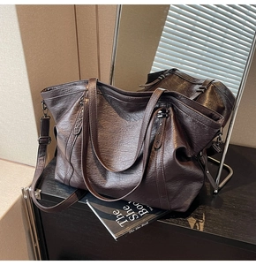 Detail of dark brown tote bag with lychee texture and star-shaped metal rivets