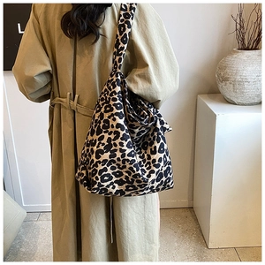 Detail of trendy leopard print canvas crossbody bag showing high capacity and wide strap