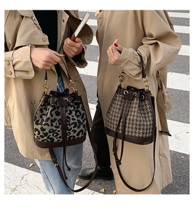 Detailed view of drawstring bucket bags in leopard print and houndstooth patterns