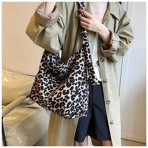 Detailed view of leopard print canvas tote bag with a stylish knotted shoulder strap