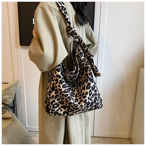 Detail of hobo leopard print canvas tote bag with stylish shoulder strap knot detail