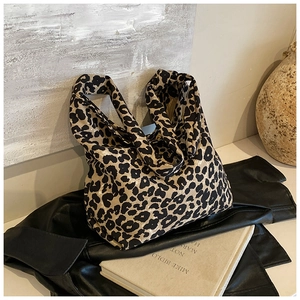 Artistic detail of leopard print canvas tote bag with large capacity in a chic setup
