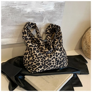 Detailed view of leopard print canvas tote bag on vintage background with soft lighting