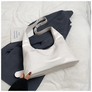 Close-up of pearl white hobo bag featuring adjustable strap and silver metal buckle
