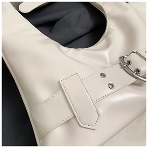 Detail of off-white PU leather shoulder bag featuring silver buckle belt decoration