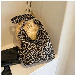 Detail of soft leopard print canvas tote bag with spacious interior and warm aesthetic