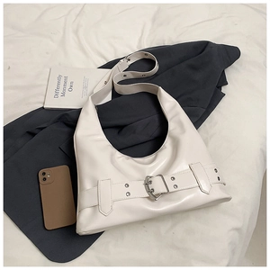 Detailed top view of a cream white PU hobo bag with industrial metal buckles and wide straps